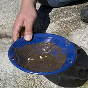 image of pan using gold pan to sift through dirt to find gold in water