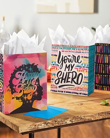 Colorful birthday gift bags in pink, blue and orange for mom, sister, daughter, or best friend