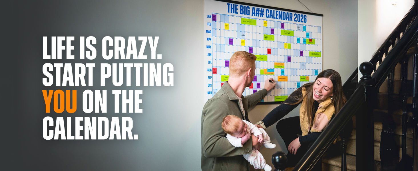 Two parents and a child on a staircase, using a giant wall calendar
