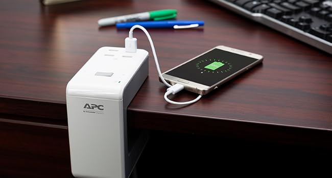 Multiple devices connected to the PE6U4 SurgeArrest at the base of a desk