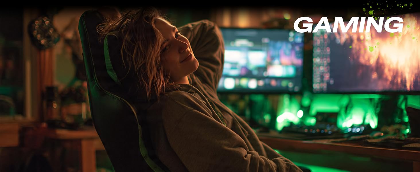 Woman smiling at gaming desk using ergonomic mouse pad with wrist rest support