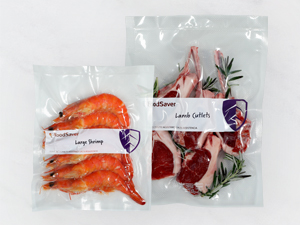 Two vacuum-sealed bags with shrimp and lamb cutlets