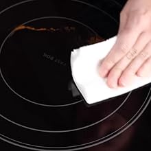 hand cleaning up the residual mess with a paper towel