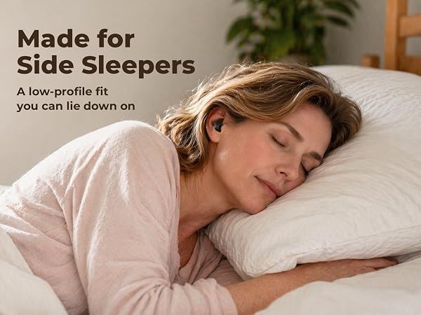 Woman sleeping on her side in bed wearing a tiny low-profile wireless earbud