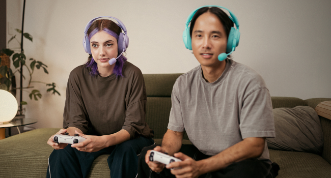A woman and a man wearing headsets and gaming together