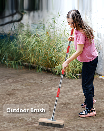 woman using a garden tool to clean a garden