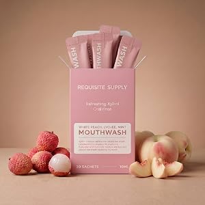 Mouthwash product next to lychee and white peach.