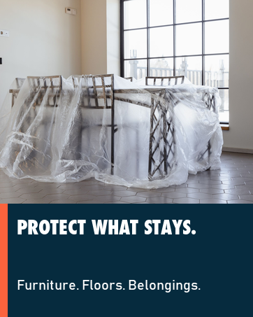 Real home interior protected with a clear plastic drop cloth during decorating.