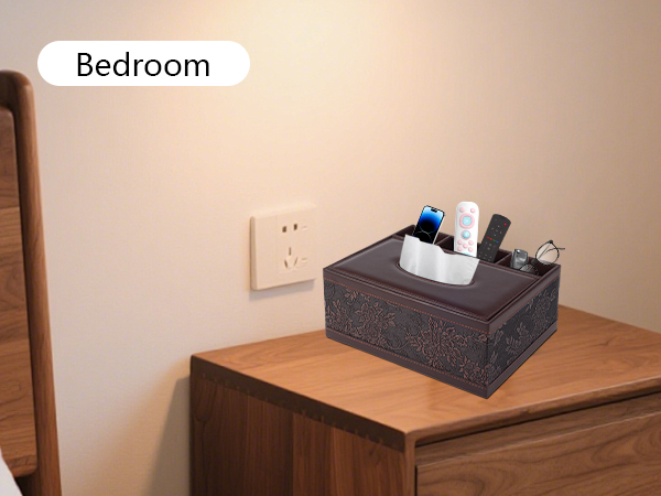Text reads: 'Bedroom'. Gray storage box containing personal items on wooden bedside table against white wall with electrical outlet.