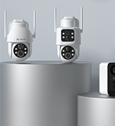 Close-up of two security cameras mounted on grey surface, showing white cylindrical housings with dark lenses.