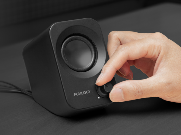FUNLOGY Speaker Plus front volume dial being adjusted by hand.