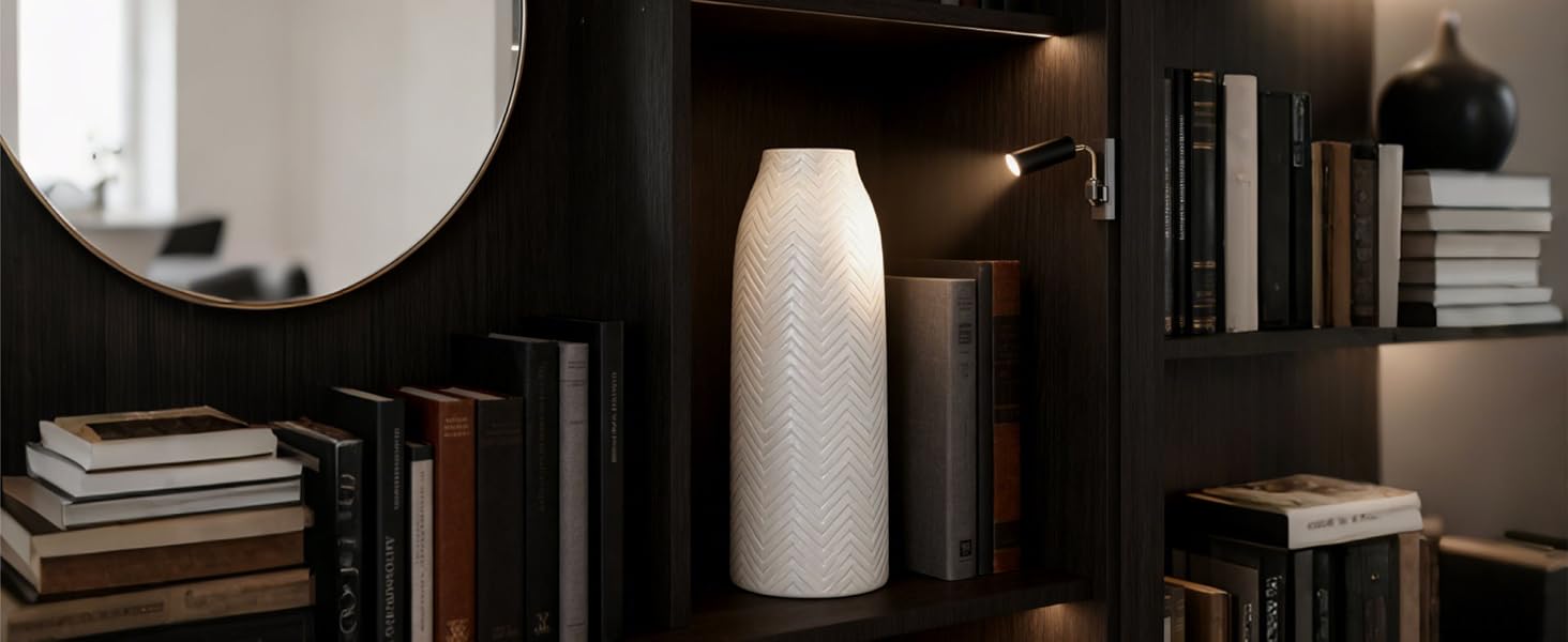 In a dark wood multi-layer bookshelf scene, a white ceramic vase with herringbone texture