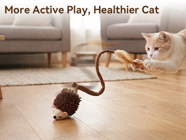 Text reads 'More Active Play, Healthier Cat'. Cat playing with brown toy mouse on wooden floor near gray couch in bright living room.