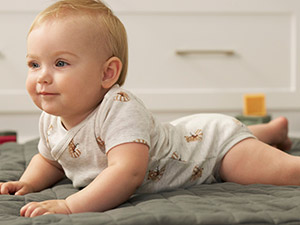 baby wearing gray heathered bodysuit