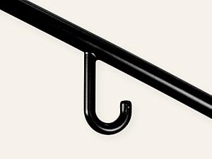 Close up of J-shaped shoulder hook on black plastic hanger. Grips camisole and bra straps securely.