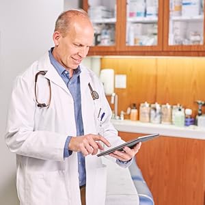Doctor reviewing a patient's medical report on a tablet