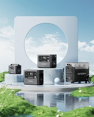 Portable power stations displayed on reflective surface with sky background. Multiple gray devices with digital displays and various ports visible.