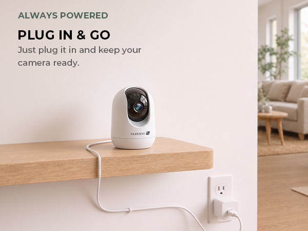 White indoor camera plugged into a wall outlet in a home.