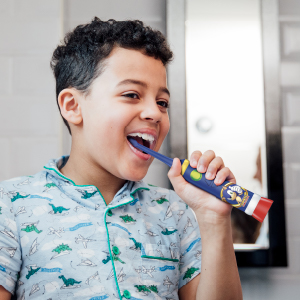 Boy brushing teeth with Firefly Sonic the Hedgehog toothebrush