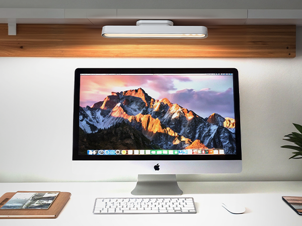 a desk with a computer and a mouse