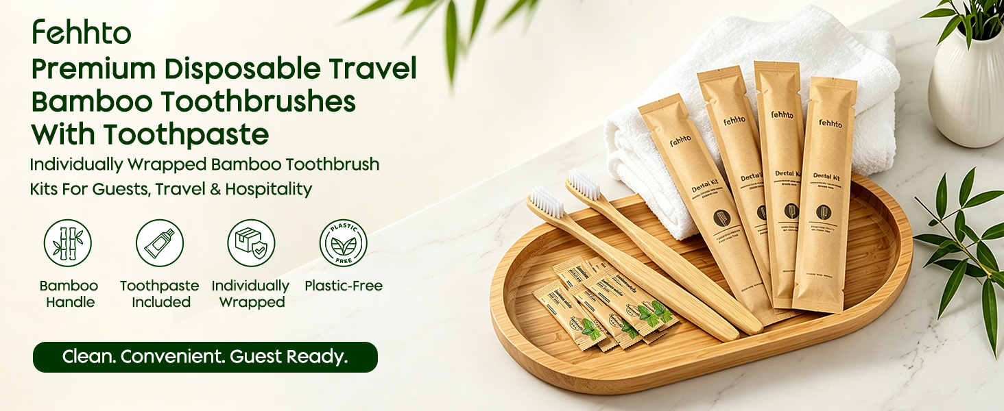 Bamboo toothbrush dental kits on a bamboo tray with towels and green leaves.