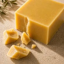 Refined beeswax block with smooth texture on neutral surface, representing clean formulation