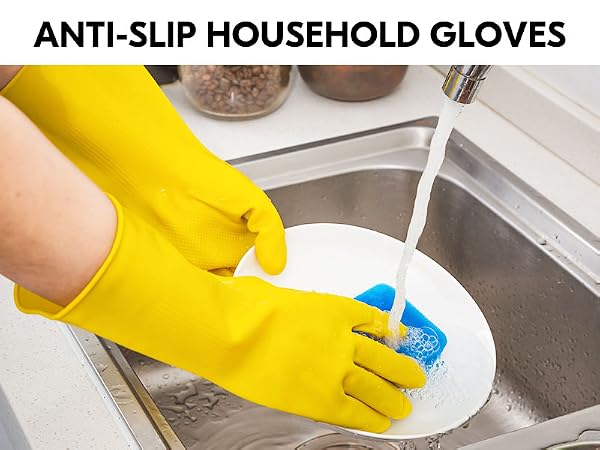 Bright yellow anti-slip household gloves shown in use, washing a white plate with a blue sponge in a stainless steel sink under running water.