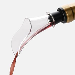 a bottle of wine being poured into a wine bottle.