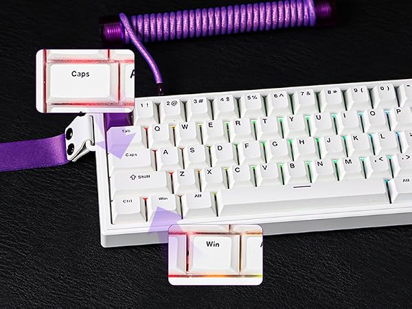 White mechanical keyboard with colorful keycaps. Purple coiled cable attached. Two small cards labeled 'Caps' and 'Win' visible. Purple decorative elements on keyboard.