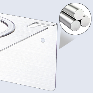 Close-up of a white electronic device corner, showing circular metal connectors or ports. Partial view suggests a larger appliance or gadget.