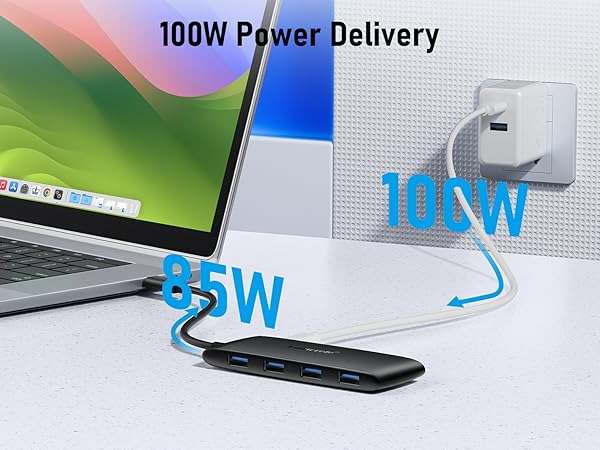 Text reads '100W Power Delivery'. Product demonstration showing power delivery capability between device and laptop, with wattage indicators.