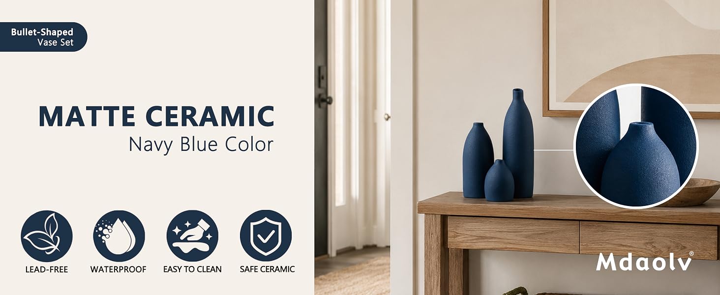 Matte navy blue ceramic vase set with textured finish displayed on a wooden console table