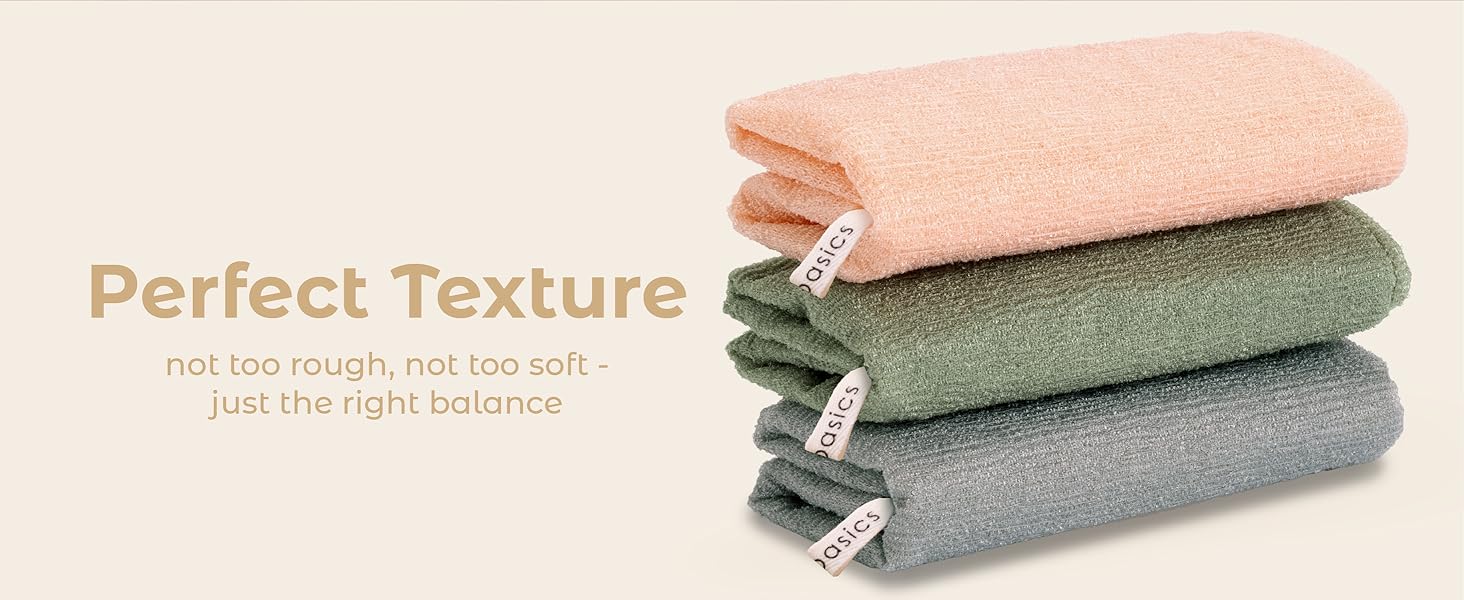 Soft yet textured body scrub towel stack for effective cleansing.