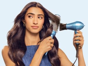 Woman using hair dryer