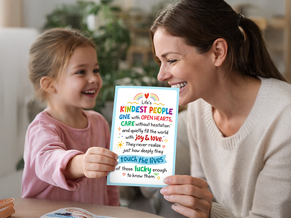 A photo of a girl giving a school counselor appreciation card to her teacher.