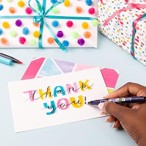 image of card designed and lettered using Fudenosuke marker with presents in the background