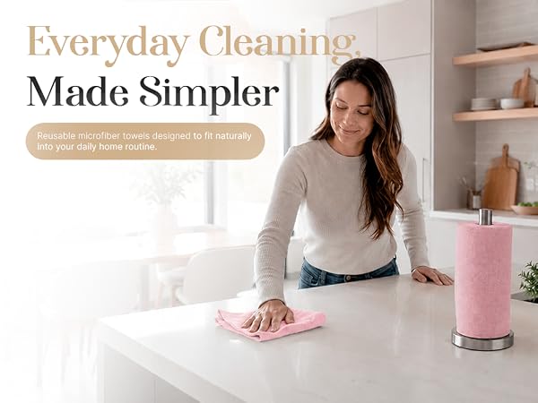 Woman cleaning kitchen counter with reusable pink microfiber towel