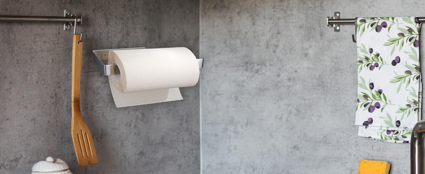 Wall-mounted paper towel holder with floral wallpaper accent visible in background. Multiple views show chrome fixture against gray concrete wall.