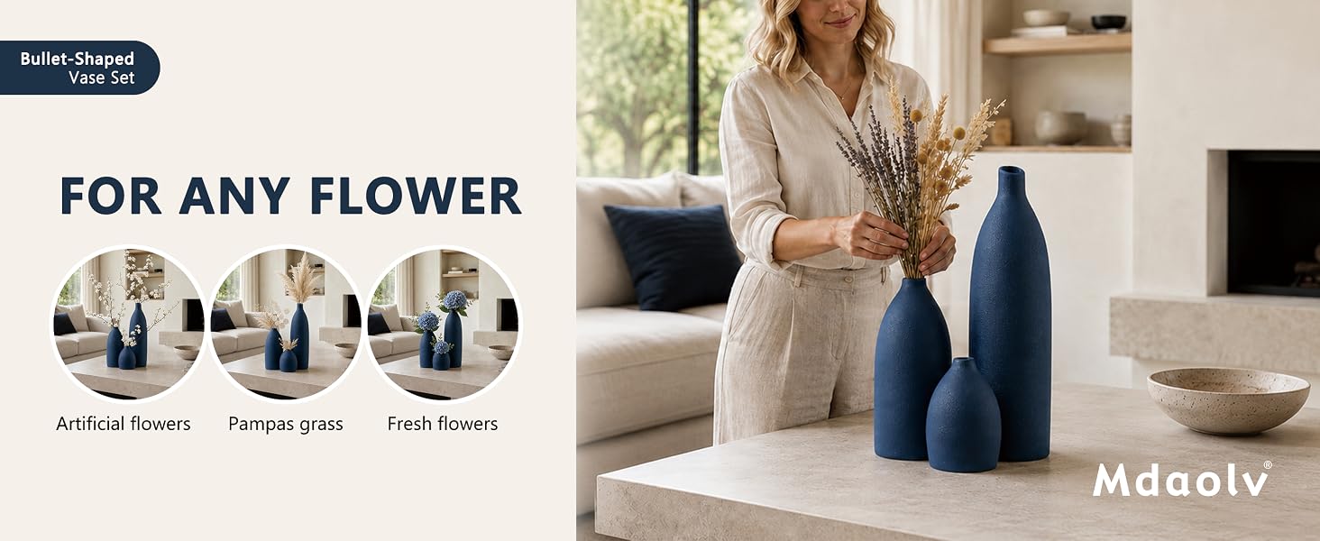 Navy blue ceramic vase set styled with artificial flowers, pampas grass, and fresh flowers