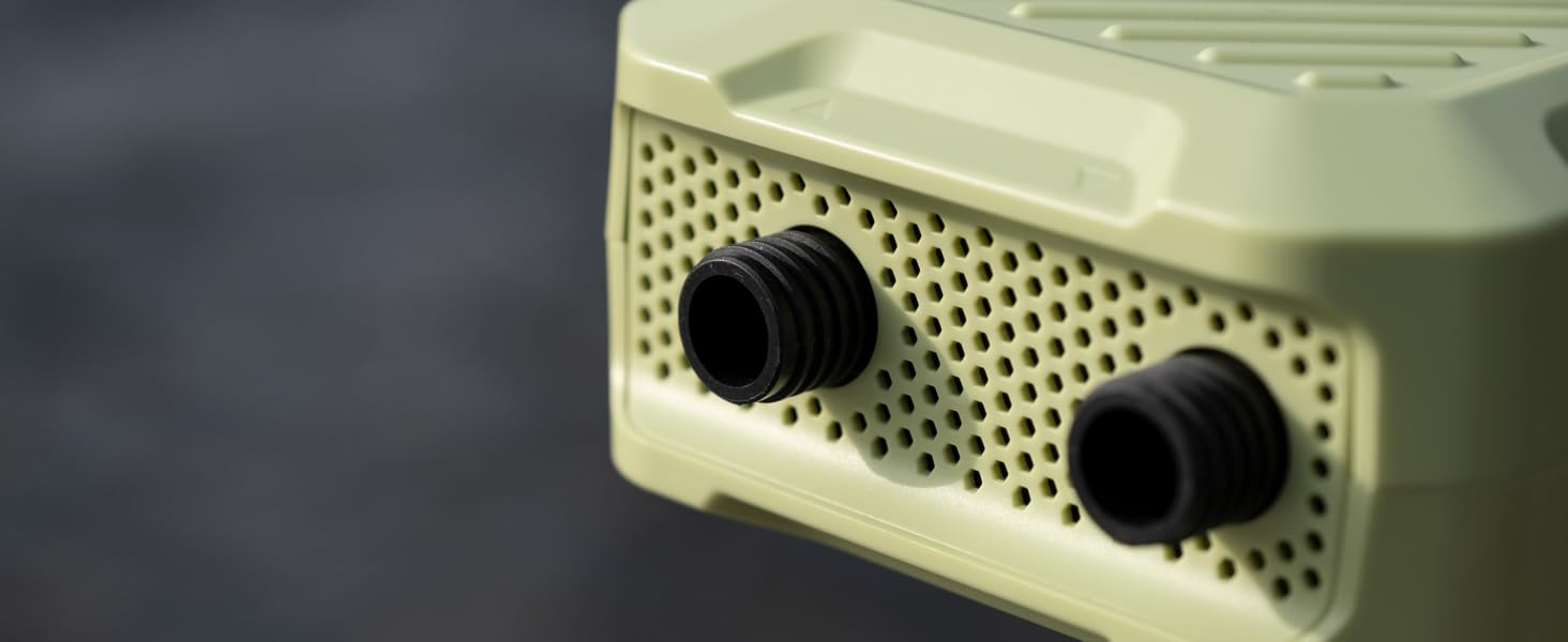 Close-up of a beige electronic device with perforated front panel and two black knobs, possibly a vintage radio or speaker.