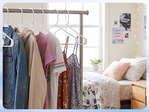 Laundry room: transferring dry clothes onto plastic hangers white straight from dryer. No wrinkling