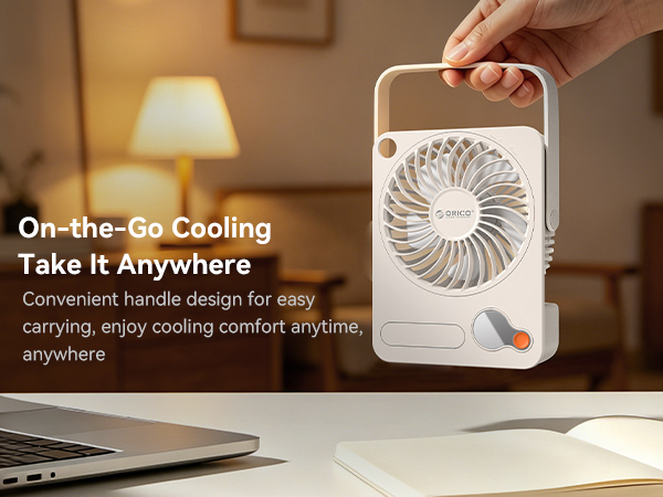 Text reads 'On-the-Go Cooling Take It Anywhere' and 'Convenient handle design for easy carrying, enjoy cooling comfort anytime anywhere'. White handheld fan device with handle held by hand in warm-lit room.