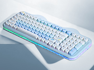 White mechanical keyboard with light blue accents and backlit keys photographed at an angle on a light surface.