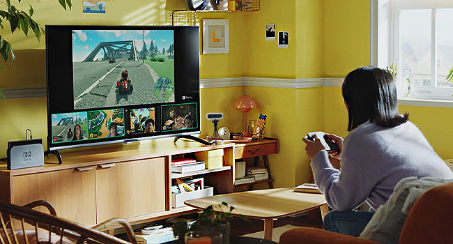 Person playing Mario Kart on Switch. TV shows gameplay and video chat with other players
