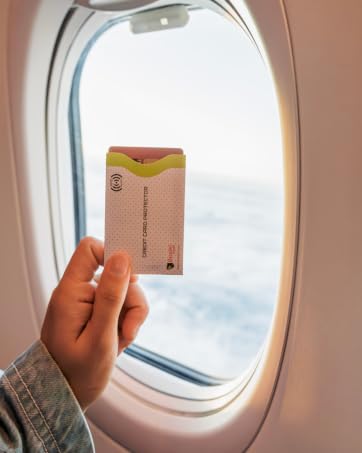RFID credit card protector sleeve held on airplane, secure travel essential for identity safety