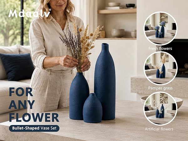 Matte navy blue ceramic vase set with textured finish displayed on a wooden console table