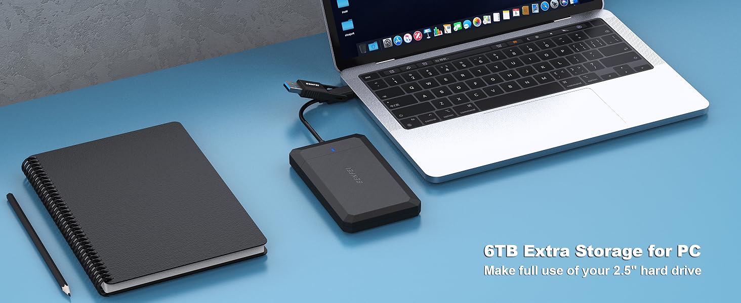 Laptop, black notebook, and external hard drive on blue surface. Text reads '6TB Extra Storage for PC' indicating hard drive capacity.