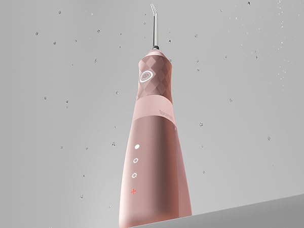 pink water flosser with water drops