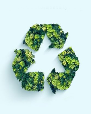 Recycling symbol formed from green moss or foliage against light blue background, creating an eco-friendly environmental concept.