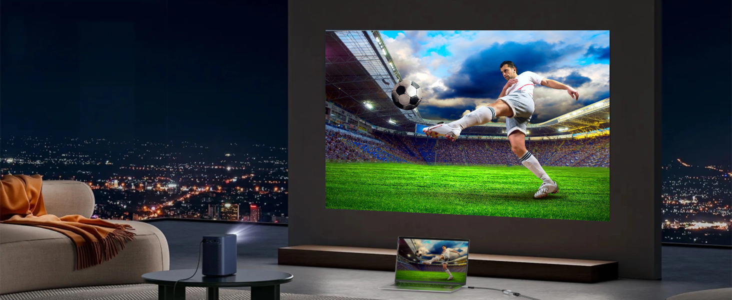 Large wall-mounted display showing soccer match, with smaller display below. Living room setting with city lights visible through window.